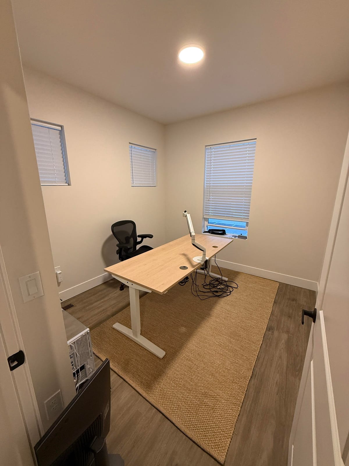 Window behind the desk: a real home office, read